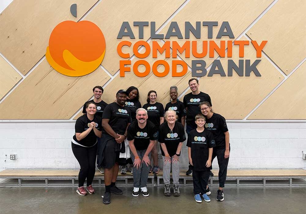 Group of volunteers posing in front of the Atlanta Community Food Bank sign